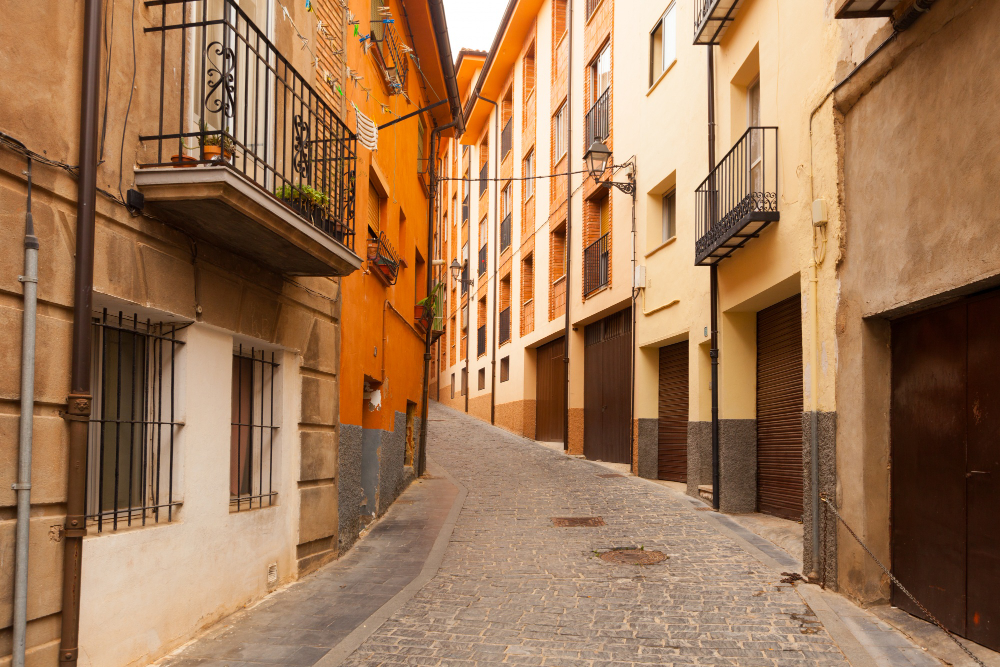 Narrow street with traditional houses in the old town of Dénia